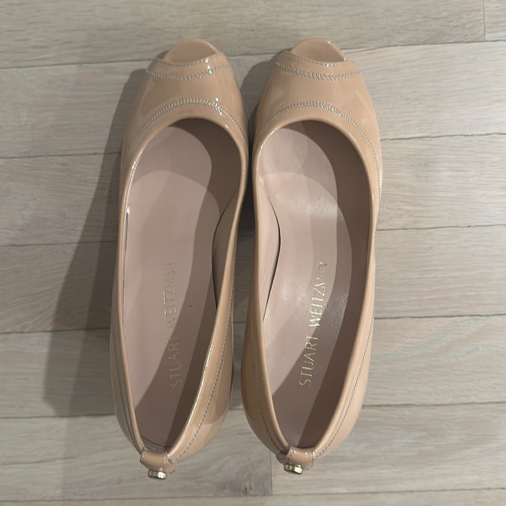 Stuart Weitzman patent leather nude peep toe pumps